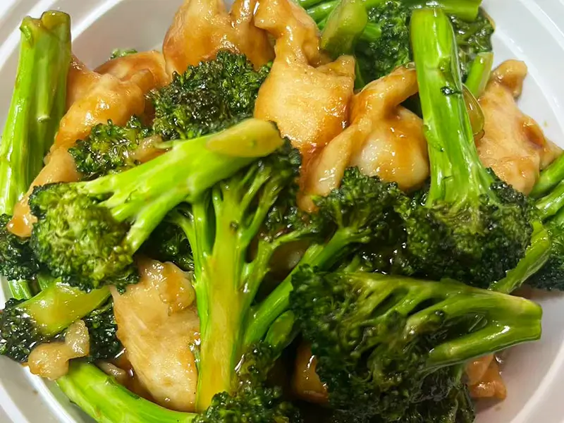 Tender chicken stir-fried with crisp broccoli at Dragon King J, a Chinese Restaurant in New York