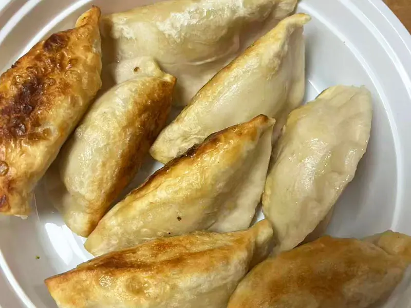 Golden crispy pan-fried pork dumplings at Dragon King J, a Chinese Restaurant in New York