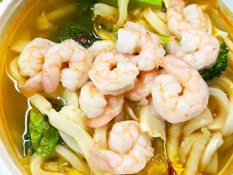 Soft noodles with plump shrimp and veggies at Dragon King J, a Chinese Restaurant in New York